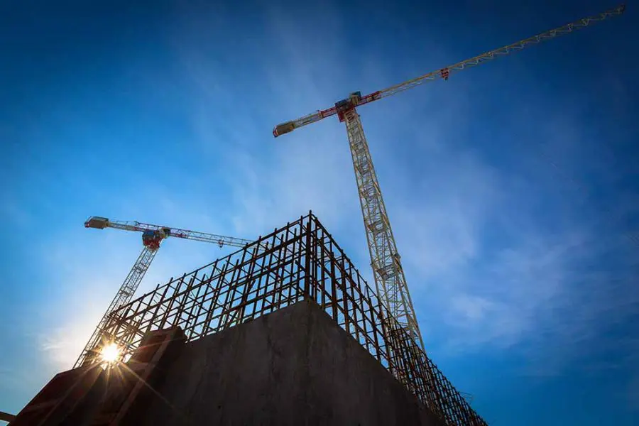 A crane standing tall above a building site